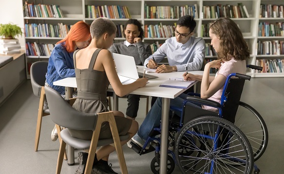 Students inclusively college mate with disability sitting at table